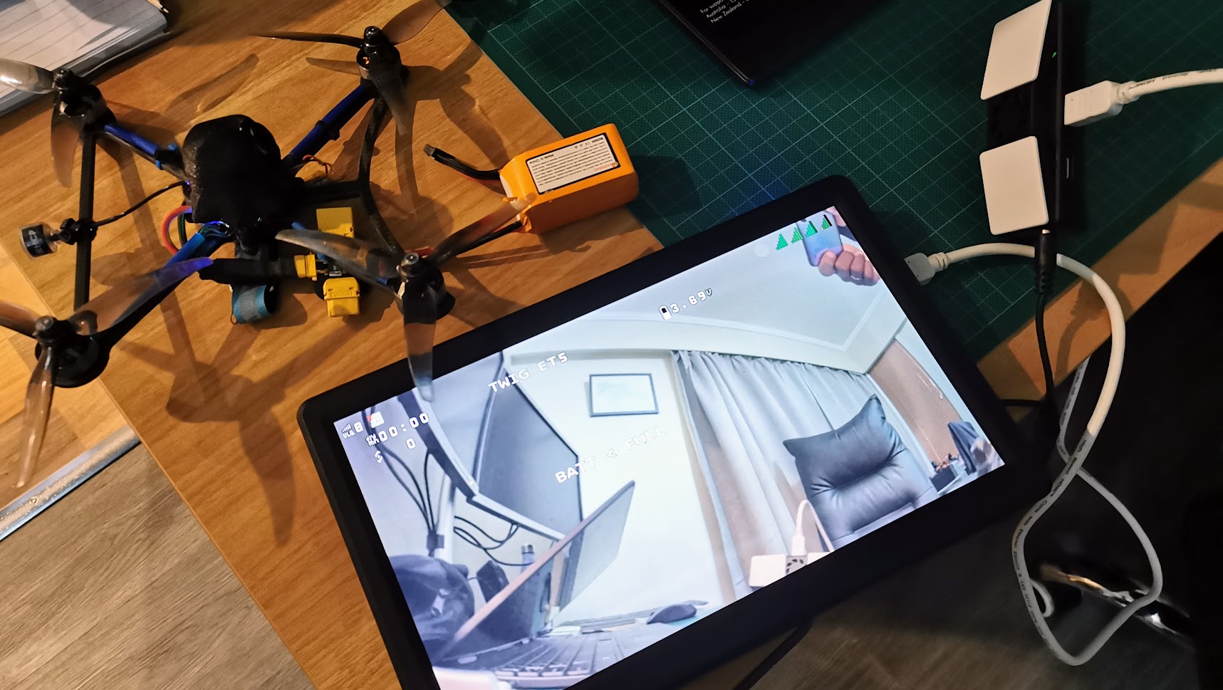 Photo of HDZero VRX connected to an LCD and displaying an image back from a nearby quad.
